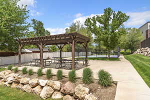 View of home's community with a pergola and a patio area
