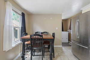 Dining area with baseboards and light tile patterned floors