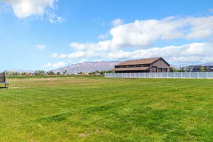 View of yard featuring a trampoline and a mountain view