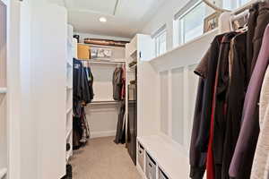 Spacious closet with light colored carpet and attic access
