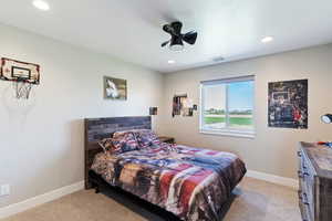 Bedroom featuring light carpet, recessed lighting, and baseboards