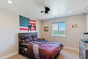 Bedroom with light colored carpet, baseboards, and recessed lighting