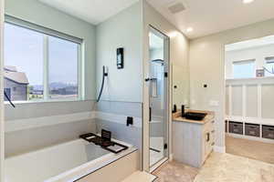 Bathroom with vanity, healthy amount of natural light, a garden tub, a stall shower, and recessed lighting