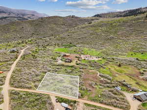 View of rural area with property parcel outlined and a mountain backdrop