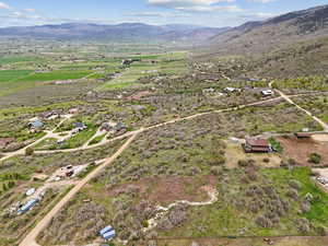 Aerial overview of property's location featuring a mountain backdrop and rural landscape