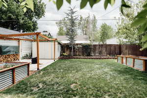 View of yard with a vegetable garden and a patio area