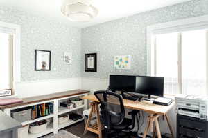 Office area with healthy amount of natural light, a wainscoted wall, and wallpapered walls