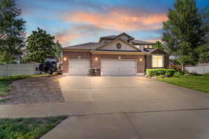 View of front of house featuring a garage, brick siding, and concrete driveway