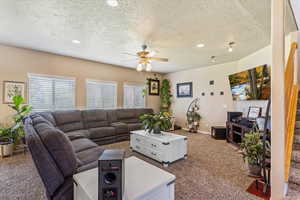 Living area with ceiling fan, carpet, plenty of natural light, a textured ceiling, and recessed lighting