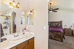 Bathroom with ceiling fan, vanity, ensuite bath, and an enclosed shower