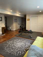 Exercise room with wood finished floors, recessed lighting, and baseboards
