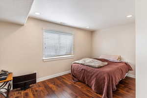 Bedroom featuring wood finished floors, baseboards, and recessed lighting