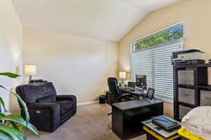 Home office with carpet, lofted ceiling, and baseboards