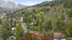 View of property location featuring property parcel outlined, a heavily wooded area, and mountains