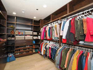 Walk in closet featuring wood finished floors