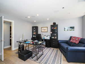 Office space featuring light wood-style floors, recessed lighting, and baseboards