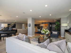 Living area with recessed lighting, light wood-style flooring, and baseboards