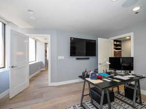 Office featuring baseboards, light wood-style flooring, and recessed lighting