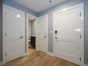 Foyer with light wood-type flooring and baseboards