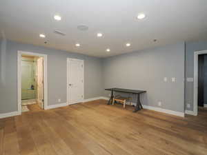 Below grade area featuring light wood finished floors, baseboards, and recessed lighting