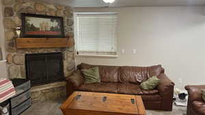 Living room featuring carpet and a fireplace