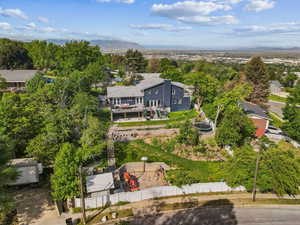 Aerial view of property and surrounding area with a mountainous background
