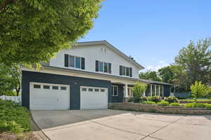 View of front of property with driveway, an attached garage, and brick siding