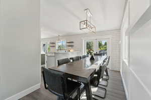 Dining room featuring french doors, wood finished floors, and baseboards