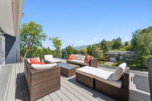 Deck featuring an outdoor living space and a mountain view
