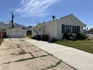 View of property exterior with an outbuilding and a detached garage
