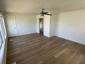Unfurnished room with wood finished floors and baseboards