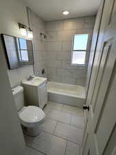 Bathroom with toilet, vanity, and bathtub / shower combination