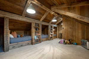 Additional living space with wooden walls, wooden ceiling, and carpet floors