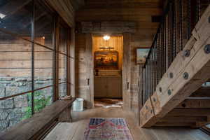Wine cellar with wooden walls and hardwood / wood-style floors