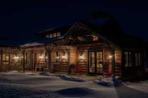 View of front facade with a chimney and french doors