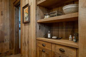 Wine cellar featuring wood walls