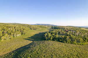 View of property location featuring a heavily wooded area and mountains