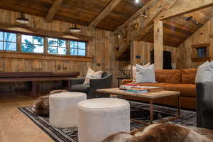 Living area with wood walls, wood-type flooring, and wooden ceiling