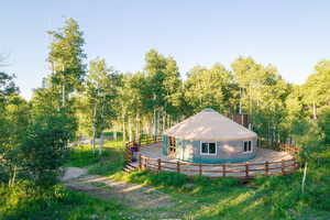 Back of property with a chimney and fence