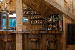 Indoor bar with lofted ceiling and wooden ceiling