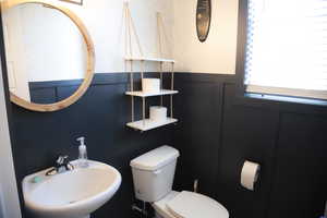 Half bathroom featuring a sink and toilet