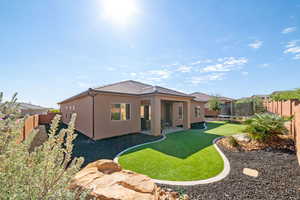 Back of property featuring a trampoline, a tiled roof, a patio area, and stucco siding