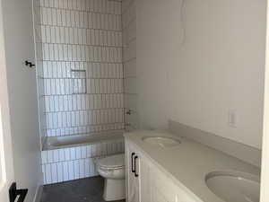 Full bathroom with tile patterned flooring, double vanity, and tiled shower / bath combo