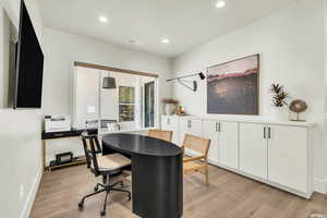 Home office featuring light wood-style floors, recessed lighting, and baseboards