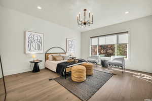 Bedroom featuring a chandelier, light wood-style flooring, recessed lighting, and baseboards