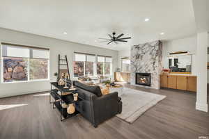 Living area with ceiling fan, wood finished floors, a fireplace, recessed lighting, and baseboards