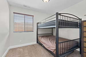 Bedroom with carpet and baseboards