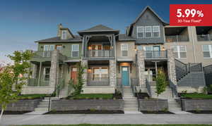 Townhome / multi-family property featuring stairway, stone siding, stucco siding, a balcony, and covered porch