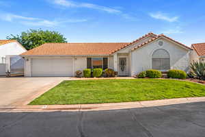 Mediterranean / spanish house with a tile roof, stucco siding, driveway, and an attached garage