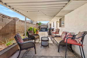 Fenced backyard with a patio area and an outdoor hangout area